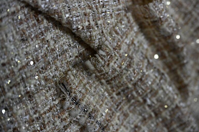 Close-up of premium Chanel-style bouclé fabric showcasing intricate texture and shimmering details, highlighting Fursone’s expertise in luxury fabric manufacturing with 7-day rapid sampling for fast fashion cycles.