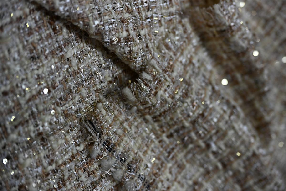 Close-up of premium Chanel-style boucl fabric showcasing intricate texture and shimmering details, highlighting Fursones expertise in luxury fabric manufacturing with 7-day rapid sampling for fast fashion cycles.