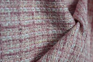High-resolution close-up image of premium tweed fabric showcasing intricate woven texture and artisan quality, representing Fursone's expertise in sourcing tweed fabric from Wenzhou. Ideal for global fashion brands seeking Chanel-style bouclé and heritage cable knits with in-stock availability and custom bespoke options.