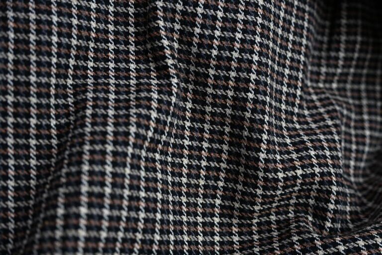 Detailed close-up of premium tweed fabric showcasing intricate weave and texture, representing Fursone's expertise in sourcing tweed fabric with Fursone. This image highlights the quality and artisan aesthetic found in our ready stock and custom bespoke manufacturing solutions.
