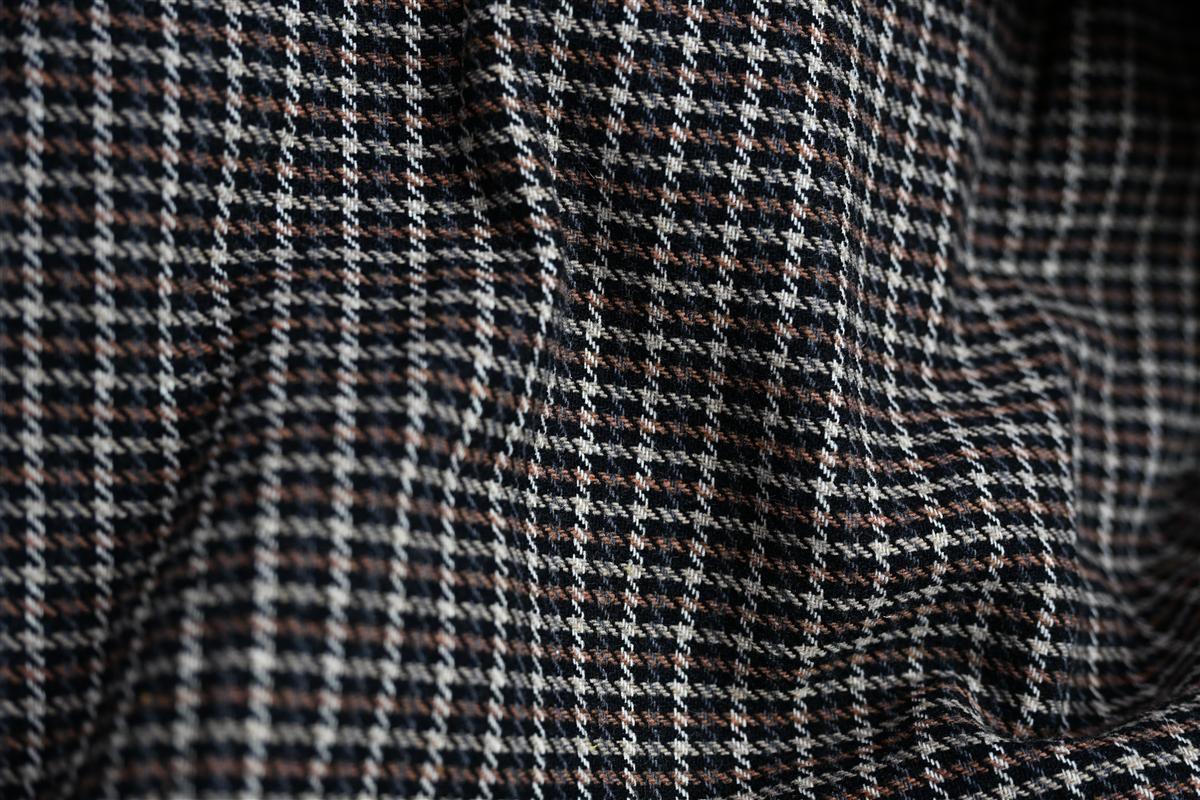 Detailed close-up of premium tweed fabric showcasing intricate weave and texture, representing Fursone's expertise in sourcing tweed fabric from Wenzhou. This image highlights the quality and artisan aesthetic found in our ready stock and custom bespoke manufacturing solutions.