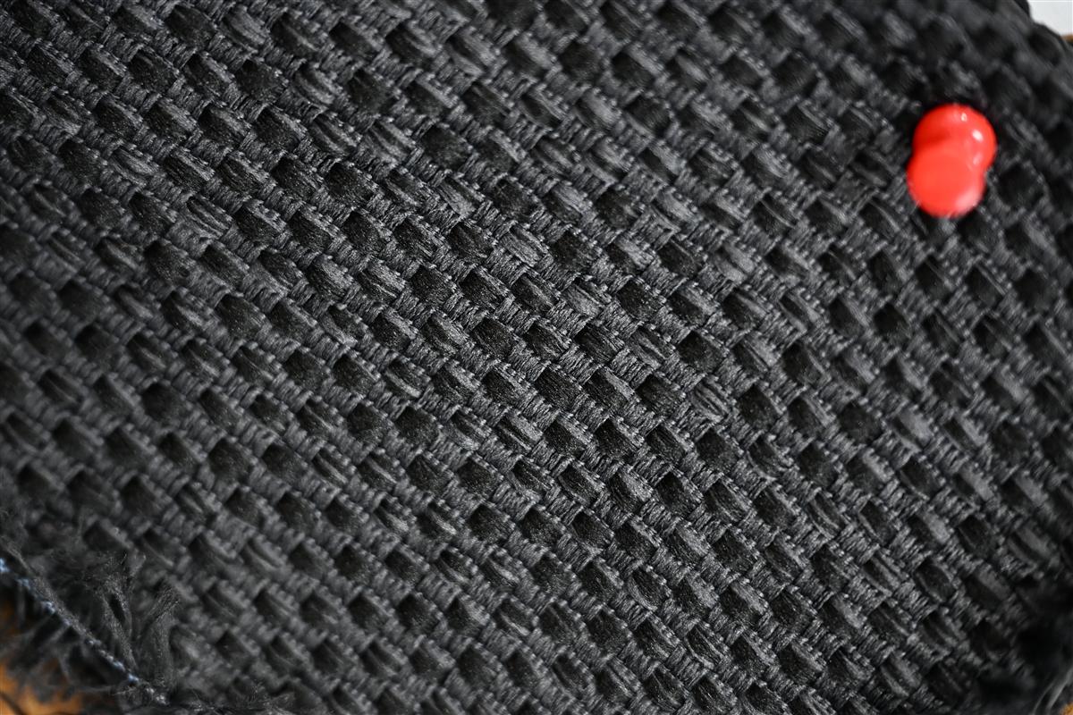 Close-up of textured black Chanel-style bouclé fabric showcasing intricate weaving details, representing Fursone's expertise in luxury fabric manufacturing and custom bespoke development from Wenzhou since 1995.
