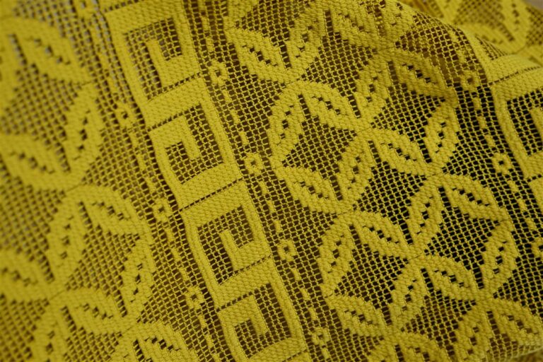 Detailed close-up of premium Chanel-style bouclé fabric showcasing intricate textured patterns, representing Fursone's expertise in knit fabric manufacturing and heritage cable knits. This image highlights the quality and artisan aesthetic available with our Ready Stock fabric and Custom Bespoke solutions from China textile manufacturing.