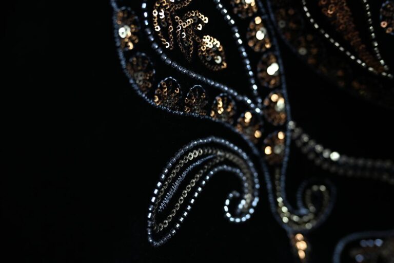 Close-up of intricate premium Chanel-style bouclé fabric showcasing detailed sequins and elegant stitching, reflecting Fursone's expertise in supplying heritage cable knits and tweed fabrics. This image highlights our commitment to affordable luxury and rapid sampling for global fashion brands from selected partner mills.