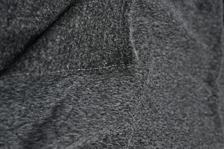 Detailed close-up of a soft, textured premium Chanel-style bouclé fabric, showcasing the artisan quality and heritage craftsmanship that Fursone offers. This fabric image represents our expertise in custom bespoke fabric development and rapid sampling for high-end fashion brands.