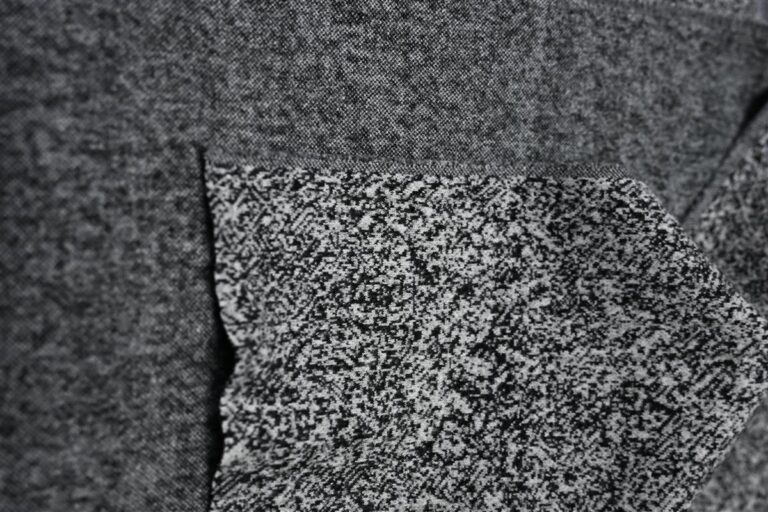 Detailed close-up of premium tweed fabric, highlighting complex yarn textures that represent Fursone's Chanel-style bouclé fabric inventory. This image exemplifies the high-quality, ready stock materials produced by China's heritage textile experts.