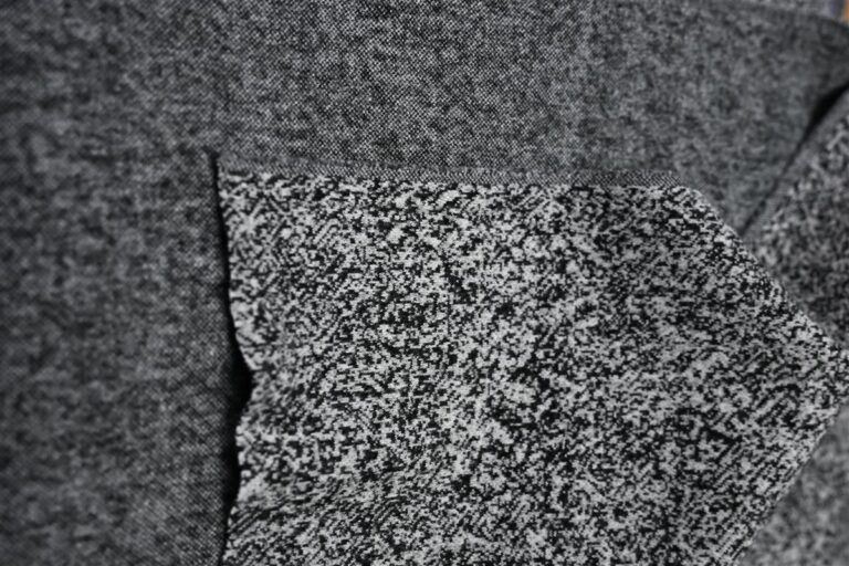 Close-up image featuring the intricate texture of Chanel-style bouclé fabric, highlighting the premium quality and craftsmanship from China Textile Expertise. This detailed fabric shot represents Fursone's commitment to luxury fabric manufacturing and ready stock availability for fast fashion cycles.