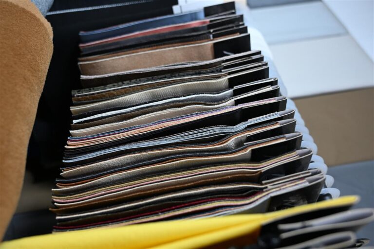 Close-up view of organized fabric swatches showcasing various textures and colors, representing Fursone’s premium Tweed Fabric Ready Stock from China. Ideal for global fashion brands seeking 3-7 day shipping and luxury material sourcing from a trusted manufacturer.