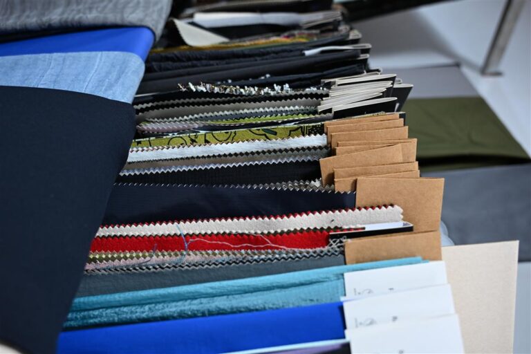 High-quality swatches of Chanel-style bouclé fabric neatly organized, showcasing Fursone's premium tweed and knit fabric manufacturing expertise since 1995. These fabric samples represent our ready stock inventory enabling fast 3-7 day shipping for global fashion brands seeking affordable luxury fabric solutions.