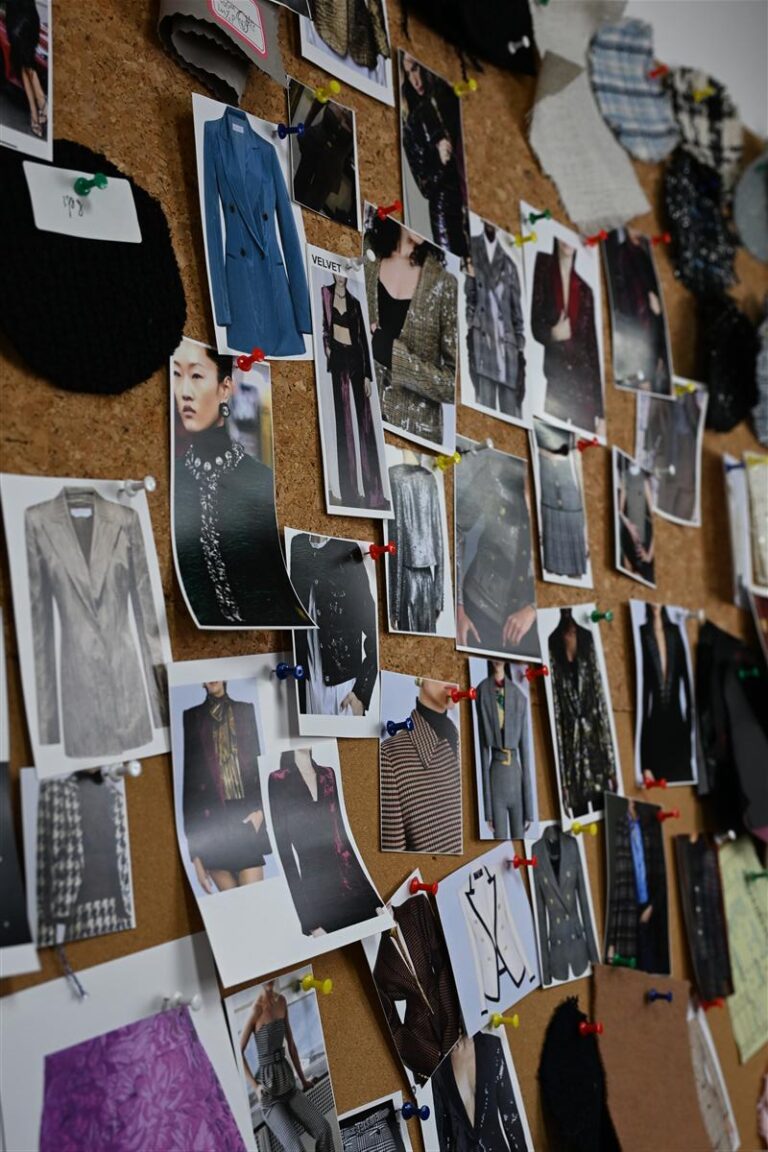 A cork bulletin board showcasing pinned fashion fabric swatches and model images, illustrating design inspiration for Fursone's custom bespoke fabric development. This detailed mood board highlights premium Chanel-style bouclé and knit textures aligned with womenswear fabric development.