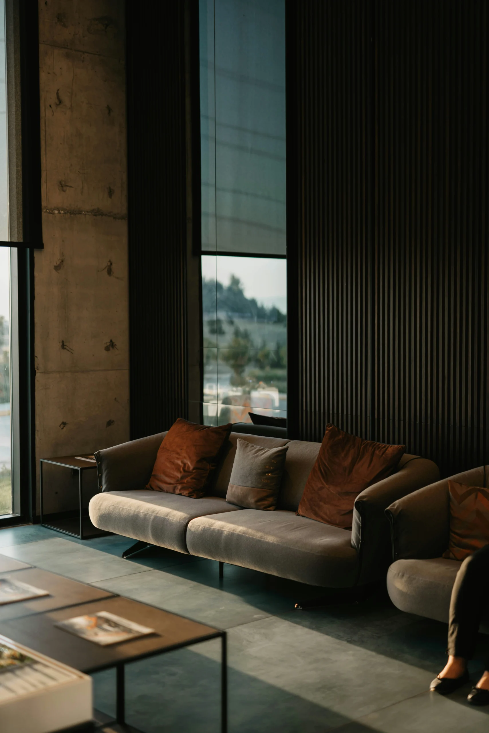 Brown and white tweed couch beside a window showing home textile use in a living room