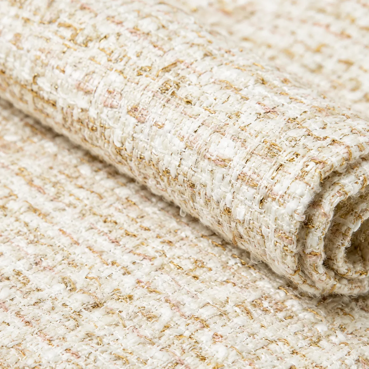 Hyper-realistic product photography, a close-up of a luxurious Chanel-style boucl tweed fabric roll with a subtle gold thread, studio lighting, sharp focus on the intricate weave texture, professional e-commerce style, no text, no brand logo