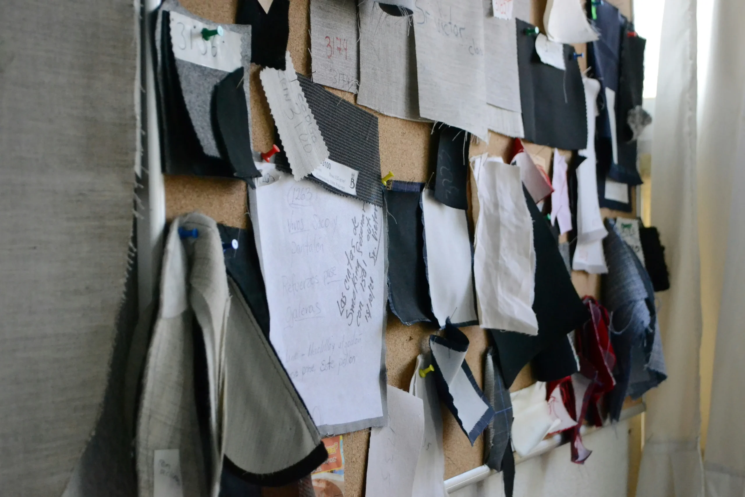Fabric swatches pinned to a corkboard illustrate Fursones Rapid Sampling: 7-Day Turnaround for Fabric Development for Chanel-style boucl, heritage knits and tweed fabrics, showcasing our Wenzhou textile expertise since 1995.